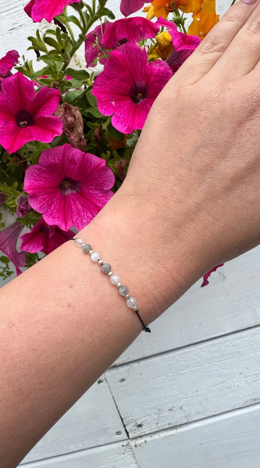 Handmade Labradorite and Moonstone bracelet with sterling silver beads and adjustable cord. Natural stones for protection, intuition, and emotional balance.