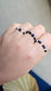 Three handmade elastic gemstone rings with Lapis Lazuli, Black Tourmaline and Moonstone beads, featuring gold and silver accents on a minimalist background.