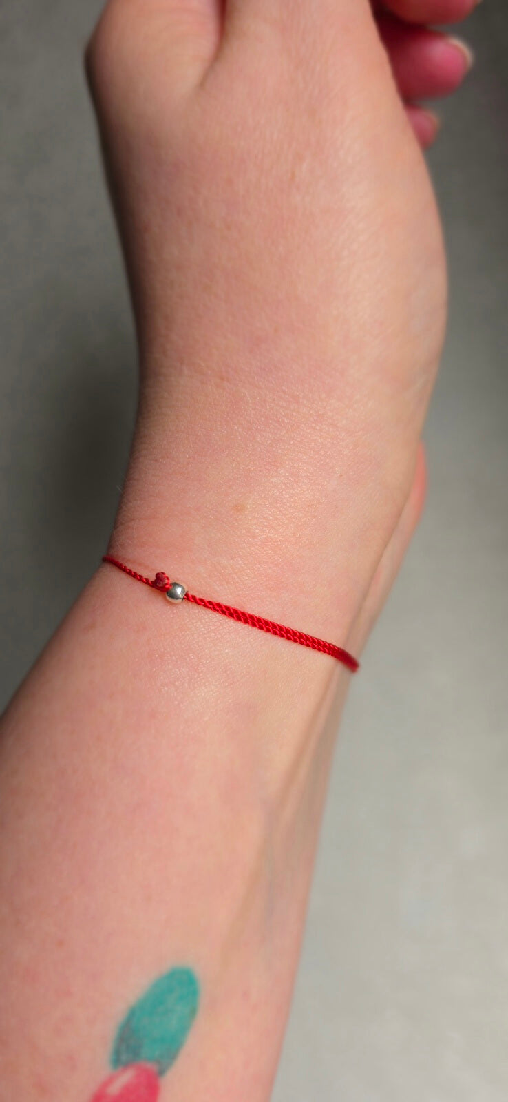 Adjustable 925 sterling silver slider beads on a red lucky charm bracelet for a perfect fit.