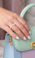 A close-up shot of the Timeless Rice Pearl Elastic Ring, featuring genuine, lustrous white rice-shaped freshwater pearls and a sparkling diamond-cut 925 sterling silver bead.