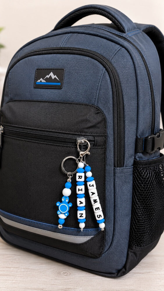 Personalized blue and white backpack and bag charm with a child’s name and cute turtle charm, handmade keychain for school bags and backpacks.
