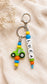 Personalised tractor name charm attached to a child's school backpack for easy identification
