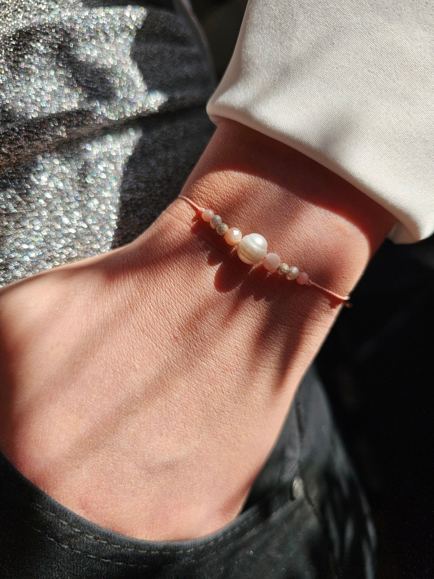 Cancer zodiac bracelet with pink opal, pearl and sterling silver
Handmade gemstone bracelet for emotional healing and intuition
Adjustable silk cord bracelet with silver slider beads
Zodiac gift for Cancer woman – delicate and feminine design
Close-up of emotional support bracelet with pink opal and pearl