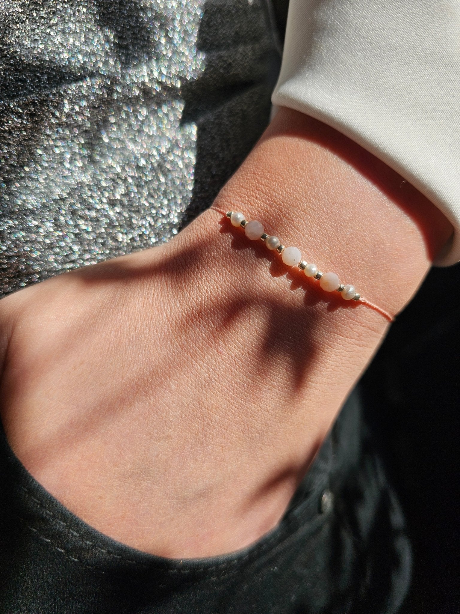 Cancer zodiac bracelet with pink opal, pearl and sterling silver
Handmade gemstone bracelet for emotional healing and intuition
Adjustable silk cord bracelet with silver slider beads
Zodiac gift for Cancer woman – delicate and feminine design
Close-up of emotional support bracelet with pink opal and pearl
