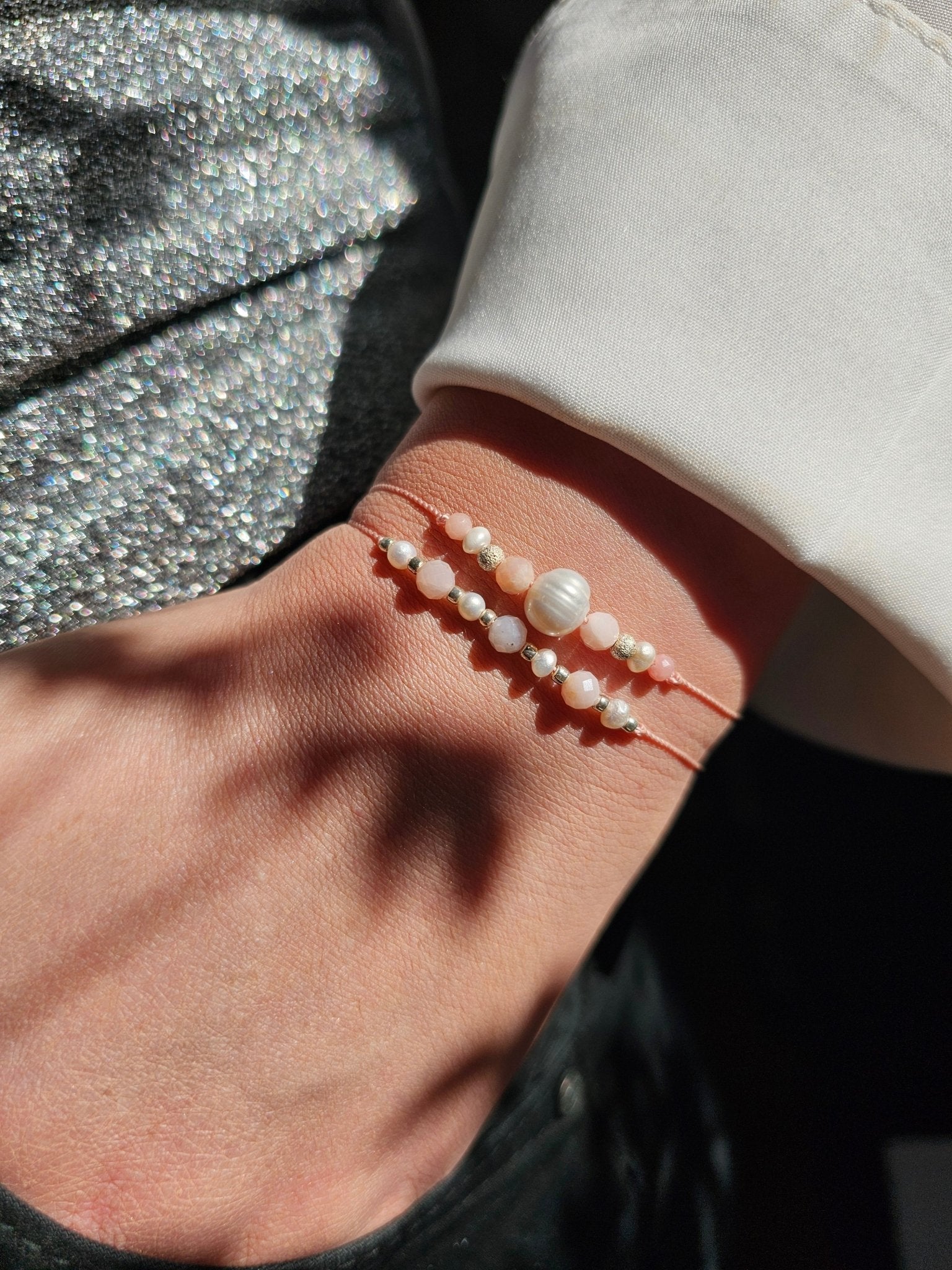 Cancer zodiac bracelet with pink opal, pearl and sterling silver
Handmade gemstone bracelet for emotional healing and intuition
Adjustable silk cord bracelet with silver slider beads
Zodiac gift for Cancer woman – delicate and feminine design
Close-up of emotional support bracelet with pink opal and pearl