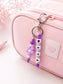 Personalised silicone name charm shown on a school backpack, lunch bag, sports bag and keys, demonstrating its versatile everyday use.
