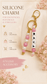 Handmade silicone bag charm with pearl and blush pink beads, displayed beautifully on natural beige linen.