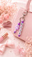 Personalised name bag charm made with soft silicone beads, clipped to a children's school backpack, perfect for identifying their bag at school.
