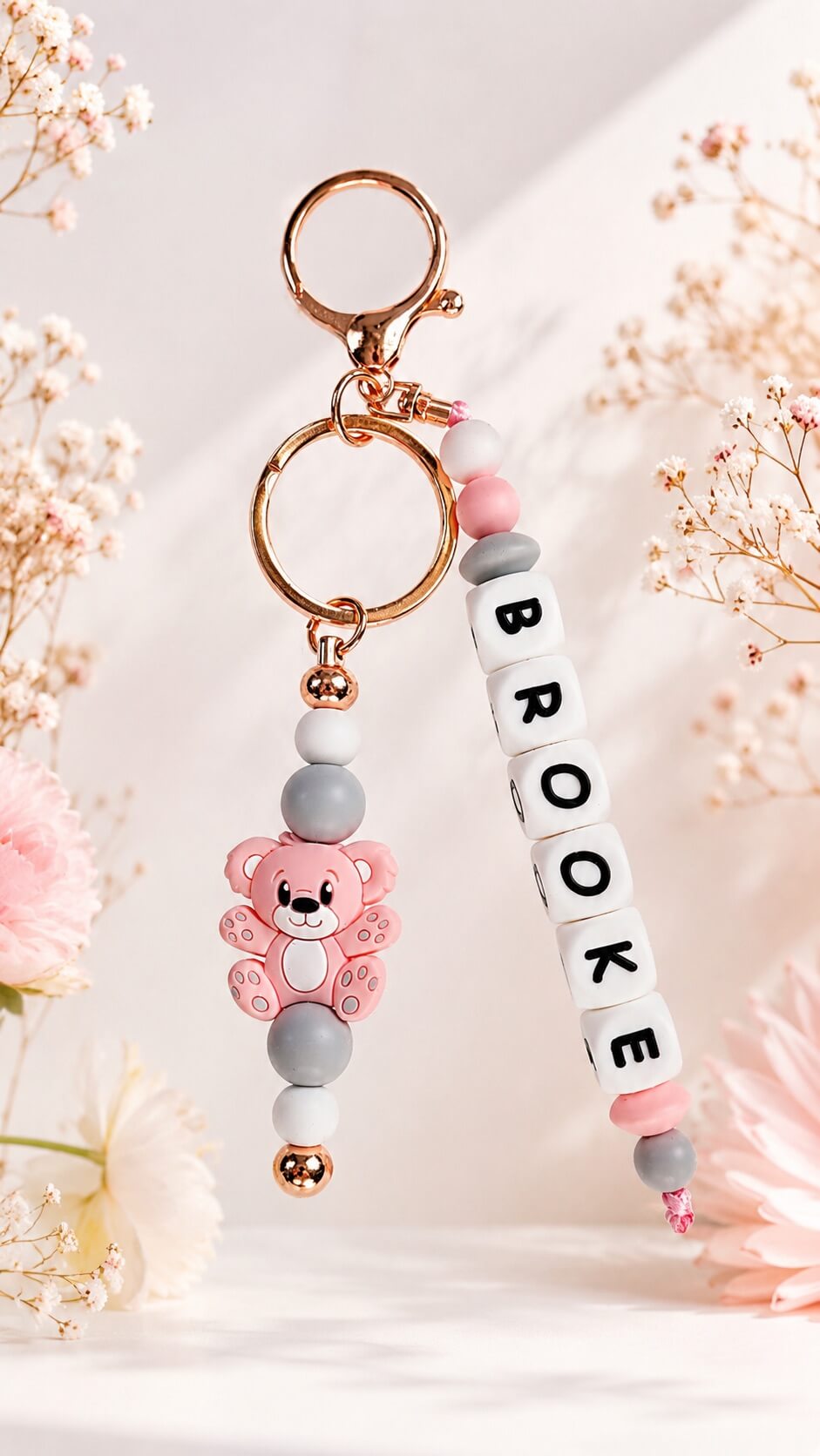 Pastel silicone bag charm with pink bear, beads and rose gold details

