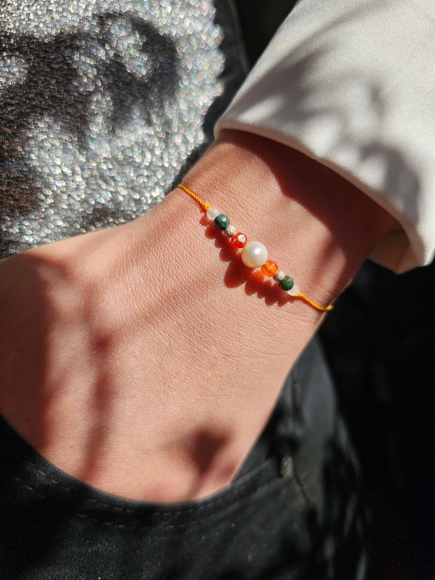 Handcrafted Gemini Zodiac Bracelet featuring natural agate and quartz gemstones on an adjustable silver cord, symbolising clarity, adaptability, and mental sharpness.