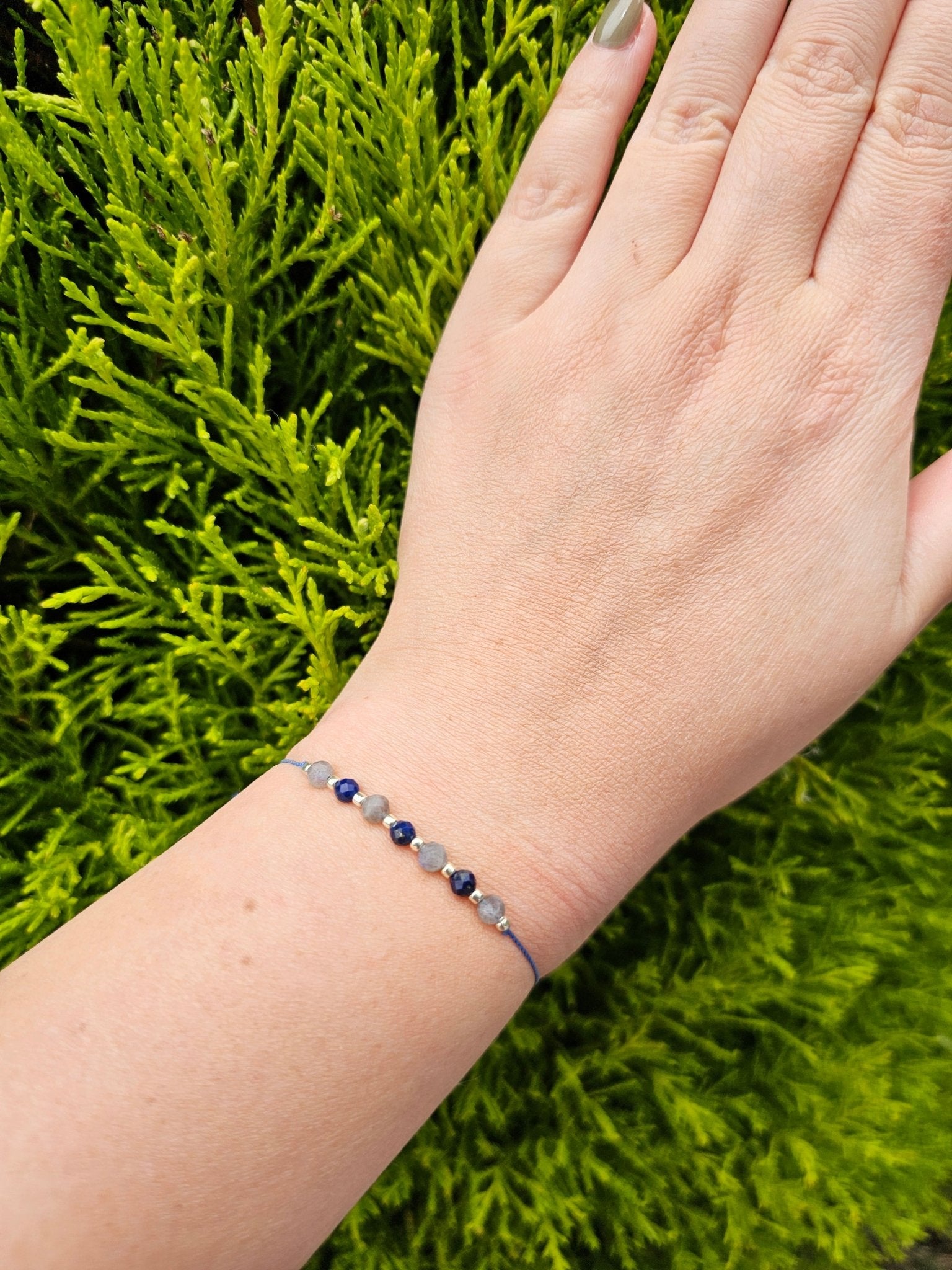 Handmade Labradorite and Lapis Lazuli bracelet with sterling silver beads on adjustable cord, combining elegance with positive energy and protection.