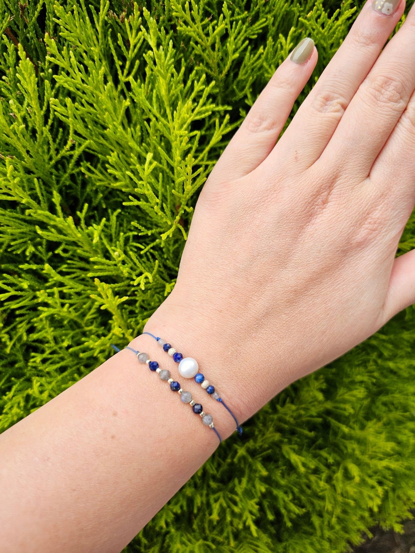 Handmade Labradorite and Lapis Lazuli bracelet with sterling silver beads on adjustable cord, combining elegance with positive energy and protection.