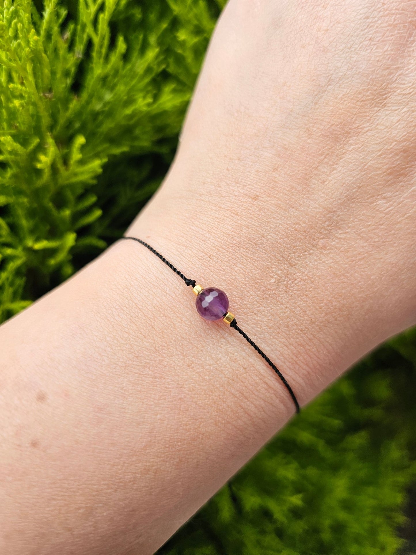 Handmade amethyst lucky bracelet for women. Spiritual jewellery with red or black cord, featuring natural stones, sterling silver and minimalist boho style. Ideal gift.

