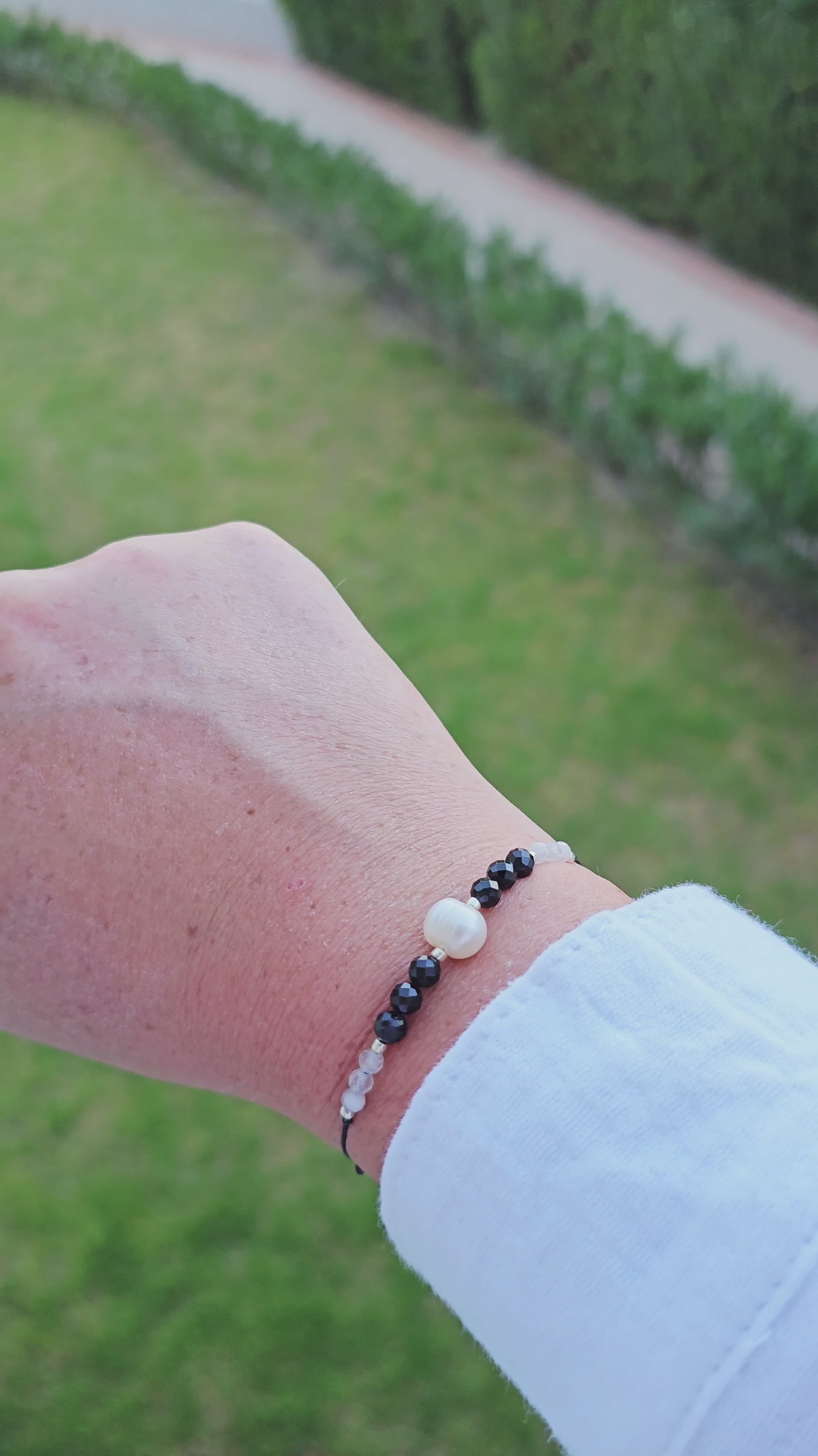 Handcrafted gift-ready bracelet with pearls, moonstone, and protective onyx stones.