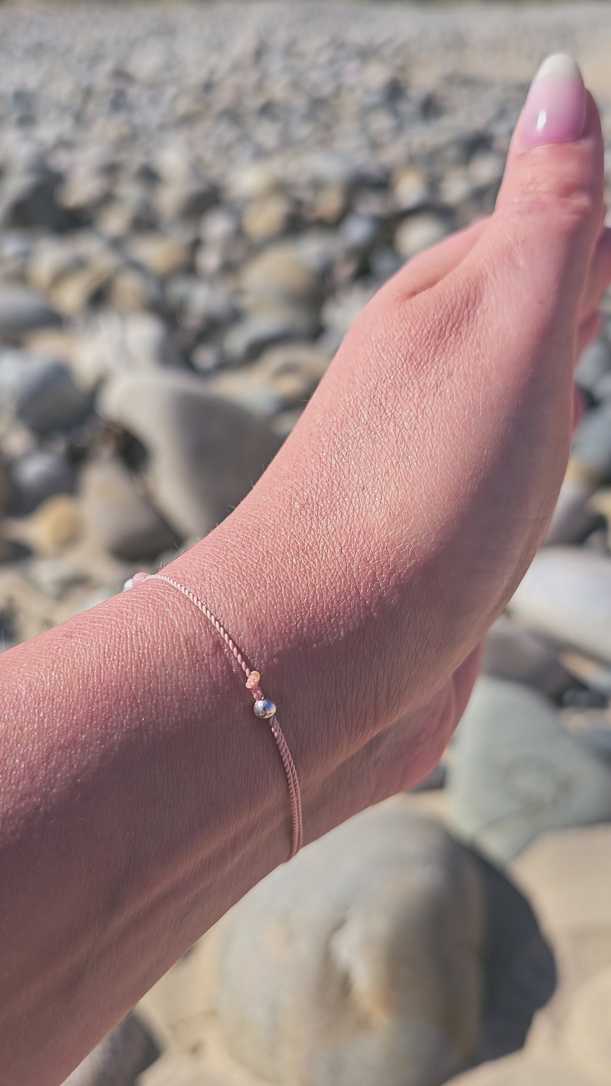 Cancer zodiac bracelet with pink opal, pearl and sterling silver
Handmade gemstone bracelet for emotional healing and intuition
Adjustable silk cord bracelet with silver slider beads
Zodiac gift for Cancer woman – delicate and feminine design
Close-up of emotional support bracelet with pink opal and pearl